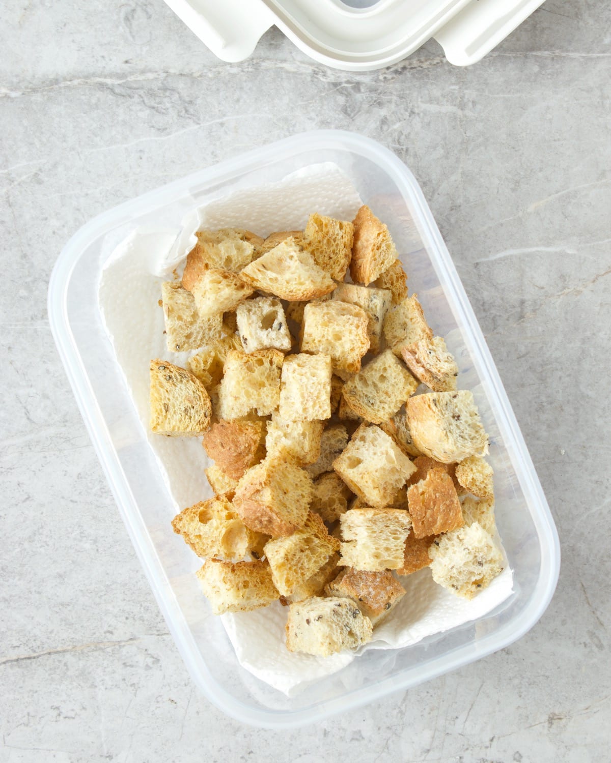 croutons in a paper-towel lined airtight container